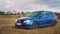 Oradea/Romania- Ã¢â¬Å½May Ã¢â¬Å½25, Ã¢â¬Å½2019: Blue Volkswagen Golf mk5 GTI on a grass field